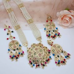 Shop These Beautiful Long Necklace Pendant Rani Haar Set for all Vibrant colors for your special events. Set Includes- Necklace, Earrings, and Matha Tikka Jewelry Care -- Keep all the jewelry away from water, perfumes, and other harsh chemicals To clean wipe with a lint-free cloth to retain the shine Please Note- No Returns No Exchange Traditional Festive Jewelry Sets With Long Necklace, Multicolor Gold Plated Jewelry For Wedding, Multicolor Gold-plated Jewelry For Wedding, Festive Long Necklace Jewelry Set For Wedding, Long Pearl Necklace For Wedding And Festivals, Festive Wedding Jewelry Sets With Long Necklace, Kundan Long Necklace For Wedding And Festivals, Traditional Long Necklace Jewelry Set For Festivals, Traditional Festival Jewelry Set With Long Necklace