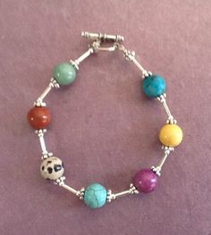 This colorful summer pastel bracelet will go with almost anything you choose to wear.  The gemstones include Jasper, Jade, Turquoise and Quartz. This pretty multicolor bracelet will be a fun accent to pick up often because the colors will add interest to so many outfits. The colors include turquoise, yellow, purple, blue, peach, and green. It has silver spacers, small silver tubes, and a silver toggle closure. , 8 1/4 inches long Pastel Bracelet, Multicolor Bracelet, White Pearl Jewelry, Semi Precious Stone Bracelet, Orange Jewelry, Summer Bracelet, Orange Necklace, Fun Bracelet, Brown Bracelet