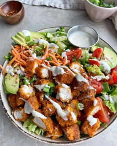 a salad with chicken and dressing in a bowl