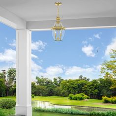 an open porch with a view of a pond and golf course in the back ground