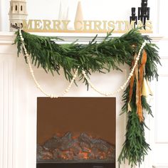 a fireplace decorated for christmas with garland and lights