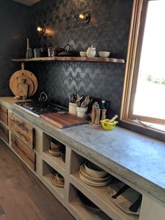 the kitchen counter is made from wood and has many dishes on it, including bowls