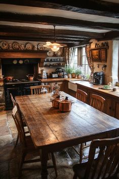 a wooden table sitting in the middle of a kitchen next to a stove top oven