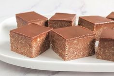 several pieces of brownie on a white plate