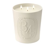 a white candle holder with three candles in it