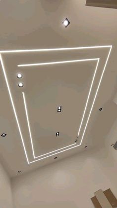 an overhead view of the ceiling in a room with white walls and square lights on it