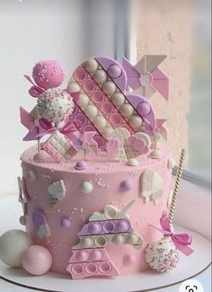 a pink cake with lots of decorations on it