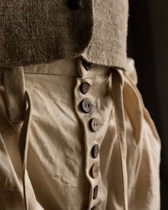 Wide-leg Cotton Harem Pants With Belt Loops, Linen Trousers With Buttons, Wide Leg Linen Pants With Buttons, Vintage Cotton Bottoms With Buttons, Beige Linen Bottoms With Button Closure, Beige Linen Bottoms With Buttons, Vintage Wide Leg Linen Bottoms, High-waisted Beige Pants With Buttons, Cotton Trousers With Buttons