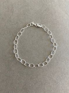 Sterling Silver Oval Rolo Chain Bracelet - Sterling Silver ★ Quantity : One Piece ★ Color : Silver ★ Materials : Sterling Silver ★ Width : 5mm ★ Length : 7.5 inches  ★ Suitable for delicate and sensitive skins. ★ All purchases come in a small gift box perfect for gift giving. Multiple items will be boxed together. If you need extra boxes for gifting....just let us know! Minimalist Oval Bracelets For Everyday Wear, Dainty Oval Bracelet For Everyday, Oval Bracelet With Adjustable Chain For Everyday, Oval Adjustable Chain Bracelet For Everyday, Adjustable Silver Chain Bracelet With Oval Links, Adjustable Oval Link Silver Chain Bracelet, Minimalist Silver Oval Bracelets, Minimalist Oval Chain Bracelet Gift, Adjustable Oval Bracelets