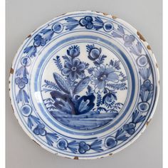 a blue and white plate with flowers on it