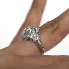 *VIEW A VIDEO OF THIS RING* https://youtu.be/Malcez6MWnM Description: Here we have an 1910 Edwardian Platinum 1.71 Rose Cut and .25cttw Antique European Cut Diamonds Engagement Ring! This ring has a lot of beautiful and unique filigree around the shank! It stands tall all the way up to the center stone, bringing attention not only to the diamond but the metal work as well! This is a true antique piece, and we are honored to offer it to our Etsy family. This ring can be sized up or down 4 sizes f Platinum Halo Ring With Rose Cut Diamonds, Antique Gia Certified Diamond Wedding Ring, Antique Style Gia Certified Diamond Wedding Ring, Art Deco Rose Cut Cushion Cut Diamond Rings, Anniversary Halo Ring With Rose-cut Diamonds, White Gold Cushion Cut Ring With Rose Cut Diamonds, Anniversary Halo Ring With Rose Cut Diamonds, Anniversary Rose Cut Diamond Halo Ring, Antique Gia Certified Round Cut Ring