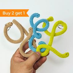 a hand is holding two pieces of rope with the word sale written out in it