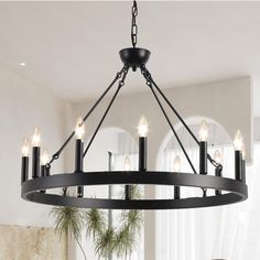 a black chandelier with candles hanging from it