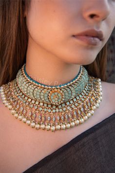 The Turquoise meenakari choker necklace is the epitome of opulence and charm. Our traditionally inspired bridal necklace celebrates the perfect amalgamation of Kundan and pearls. The extraordinary artistry of craftsmen shown in this necklace makes it a truly exceptional bridal piece.  Inspired by Indian jewelry, the meenakari necklace is a perfect statement jewel to make your look stand out.  Closure - Adjustable Dori  handcrafted in Jammu and Kashmir Paisley Pop travels the depths of India to learn techniques and crafts from deep down in the local markets and villages. We give utmost importance to our quality and packaging. Our goal is to make sure you receive exactly what you are looking for and for your experience to be a special and memorable one. We are ready to help and advise you th Luxury Spiritual Meenakari Necklace, Traditional Turquoise Necklace With Meenakari, Traditional Turquoise Meenakari Necklace, Luxury Kundan Meenakari Necklace For Reception, Traditional Turquoise Choker Jewelry, Ceremonial Blue Meenakari Jewelry, Luxury Meenakari Jewelry For Reception, Festive Turquoise Bridal Necklace For Wedding, Festive Turquoise Bridal Necklace