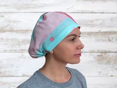 a woman wearing a pink and blue head wrap with hearts on it's side