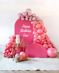 a pink birthday party with balloons and decorations