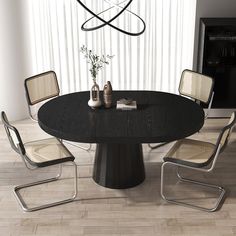 a black table with four chairs around it and a vase on top of the table