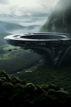 a futuristic looking building in the middle of a green valley with trees and mountains behind it