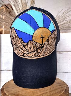 One-of-a-kind Hand Painted Hat Top Quality OTTO brand cork hat, Adjustable and comfortable, One size fits most (This is a structured style hat, not floppy or flimsy) My line of hand painted hats is inspired by the natural beauty God created in the mountains, beach, desert, and other places I like to wander. I free hand paint these designs directly on the hat.  Because of this, no two hats will ever be exactly the same.   Please see my other hat designs in my shop. These are painted using high qualitly acrylics, and then topped with a matte sealer for protection.   These will stand up to normal use, but please do not submerge in water. Everything at TheLeatherKnot is handmade by me, with Love! Fast and free shipping on every order! Burned Hat Mountains, Painted Trucker Hats, Hand Painted Western Hat, Country Style Hand Painted Brimmed Hat, Casual Hand Painted Hat, Hand Painted Trucker Hats, Custom Trucker Hats, Painted Hats, Western Boho