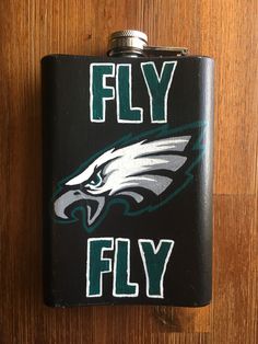 a flask with the philadelphia eagles logo on it that says, fly fiy