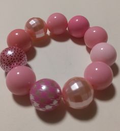 Elastic bracelet with a variety of pink beads Pink Beaded Plastic Bracelets, Novelty Pink Plastic Beaded Bracelets, Pink Adjustable Novelty Stretch Bracelet, Pink Plastic Novelty Bracelets, Adjustable Pink Novelty Stretch Bracelet, Mardi Gras Bracelet, Bubblegum Beads, Christmas Bracelet, Chunky Beads