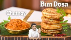 a man sitting in front of a tray with food on it and the caption bun dosa