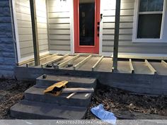 a house with steps leading up to the front door, and an empty bag on the ground