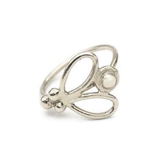 a silver ring with an open design on the front and center, set in sterling steel