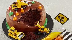 a chocolate cake with construction vehicles on it