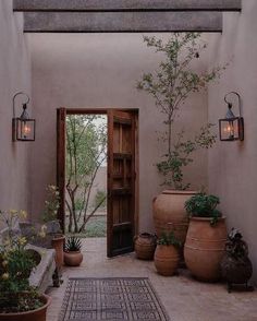 an instagram page with pots and plants on the front porch, in spanish style