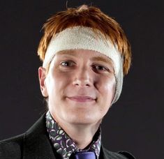 a man in a suit and tie with a bandage on his head