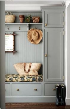 a bench with some hats on it and other items hanging from the wall behind it