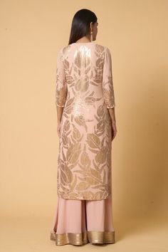 Blush pink straight kurta with lotus pattern sequin embroidery. Comes with coordinating gold sequined lotus embroidered dupatta and sequined hem farshi palazzo. - Aza Fashions Pink Sequined Kurta For Party, Slub Silk Palazzo Set With Resham Embroidery, Pink Party Kurta With Sequins, Pink Sequined Party Kurta, Elegant V-neck Palazzo Set With Resham Embroidery, Pink Sequined Straight Kurta Set, Luxury Semi-stitched Embroidered Palazzo Set, Embroidered Slub Silk Pink Palazzo Set, Semi-stitched Slub Silk Palazzo Set With Intricate Embroidery