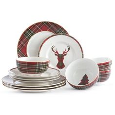 a set of dinnerware with a deer head on the front and plaid design on the back