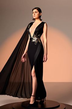 Description Black Column, Long dress Sleeveless Plunging neckline Crepe, Embroidered lace, Chiffon Modifications Accepted Custom Measurements Accepted Dry Clean Evening Dress Made in Lebanon 846 Gala Sleeveless Chiffon Evening Dress, Chiffon Sleeveless Evening Dress For Gala, Sleeveless Chiffon Gala Evening Dress, Luxury Sleeveless Banquet Dress, V-neck Evening Dress With Sheer Bodice For Gala, Sheer Bodice V-neck Evening Dress For Gala, Cocktail Evening Dress With Sheer Bodice And V-neck, Luxury V-neck Dress With Sweep Train, Embellished Sleeveless Chiffon Gown