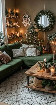 a living room decorated for christmas with candles and greenery on the walls, green couches