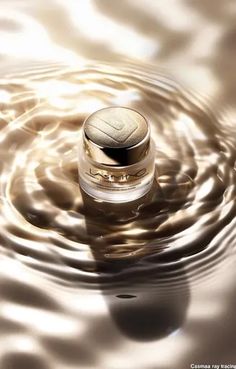 ↑↑↑ Larger size on website 🔸 A small, gold-colored jar of face cream sits in the center of a swirling, rippling pool of liquid, c 🔸 From Midjourney AI Image Gold Jars, Gold Face, The Jar, Diamond Design, Face Cream, Jade, Lab, Pool