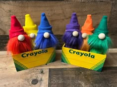 four colorful crayola gnomes with name tags on them