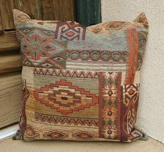 a decorative pillow sitting on the side of a building