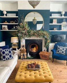 a living room filled with furniture and a fire place under a mirror on the wall