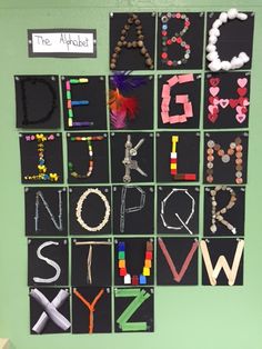 a bulletin board with letters made out of legos and beads on it's sides