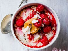 two bowls filled with oatmeal and raspberries on top of each other