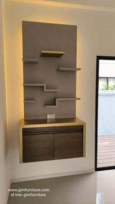 a room with some shelves on the wall and lights above it in front of a sliding glass door