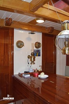 a kitchen area with wooden cabinets and lights on the ceiling, along with an island counter