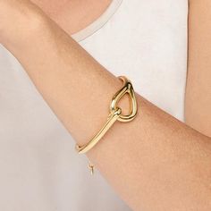 Bellezza Bronze Polished Equestrian Bangle Bracelet Elongated, wishbone-inspired swerves and curves make this bangle a sleek and modern standalone style that also looks great layered with other bracelets.        Approx. 6-1/2"L x 7/8"W with 1-1/2" extender; fits 6-1/2" to 7-3/4" wrist      Bronze; goldtone; polished finish      Chain-link extender: lobster-claw clasp Adjustable Modern Twist Bangle, Modern Twist Bangle With Polished Finish, Modern Twist Bangle For Everyday, Modern Twist Bangle For Formal Occasions, Modern Polished Bangle, Pressure Cookers, Jewelry Techniques, Wedding Watch, Hair Fragrance