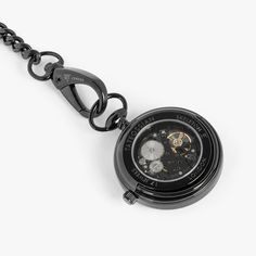 The extraordinary skeleton movement and inner mechanisms are showcased through a highly-polished glass case featuring 17 intricately placed jewels and made from brass with IP black coating. A built in safety mechanism ensures excessive winding will not damage the movement and each time the watch is fully winded, it will last for 30+ hours. Our pocket watch comes with a pocket chain finished with lobster clasps and a keyring loop to be worn in your pocket or stand alone. The perfect luxury gift t Metal Skeleton Dial Watch For Gift, Metal Skeleton Dial Watch As Gift, Metal Skeleton Dial Watch, Black Stainless Steel Round Watch Accessories, Black Stainless Steel Timeless Watch Accessories, Timeless Black Stainless Steel Watch Accessories, Black Steampunk Watch With Skeleton Dial, Elegant Metal Watches With Skeleton Dial, Black Metal Dial Watch Accessories For Formal Occasions