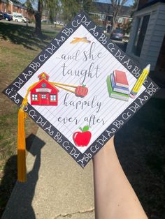 someone is holding up a graduation cap that says, and she taught happily ever after