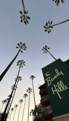 the beverly hills sign is surrounded by palm trees