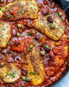 chicken with olives and tomato sauce in a skillet