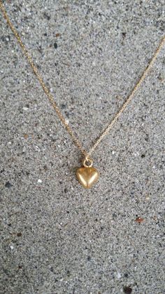 Tiny heart pendant. So cute and dainty can be worn every day with everything!The matte gold plated charm is a dainty 10mm long with a matte gold finish. It  has a delicate 14K gold fill chain with a gold filled clasp in back. Shown here in 17" length.*If you are unsure of the length you need, or would like to wear this item at different lengths, we now offer an adjustable length option! You can add an adjustable end to your necklace using this link: https://www.etsy.com/listing/791277751/necklac Cheap Delicate Chain Jewelry With Heart Pendant, Cheap Gold Heart Necklace Gift, Cheap Minimalist Heart Pendant Necklace, Cheap Minimalist Heart Charm Necklaces, Everyday Gold Heart Pendant Charm Necklaces, Everyday Gold Heart Pendant Charm Necklace, Everyday Tiny Heart Charm Necklaces, Simple Everyday Charm Necklace With Heart, Simple Everyday Heart Charm Necklace